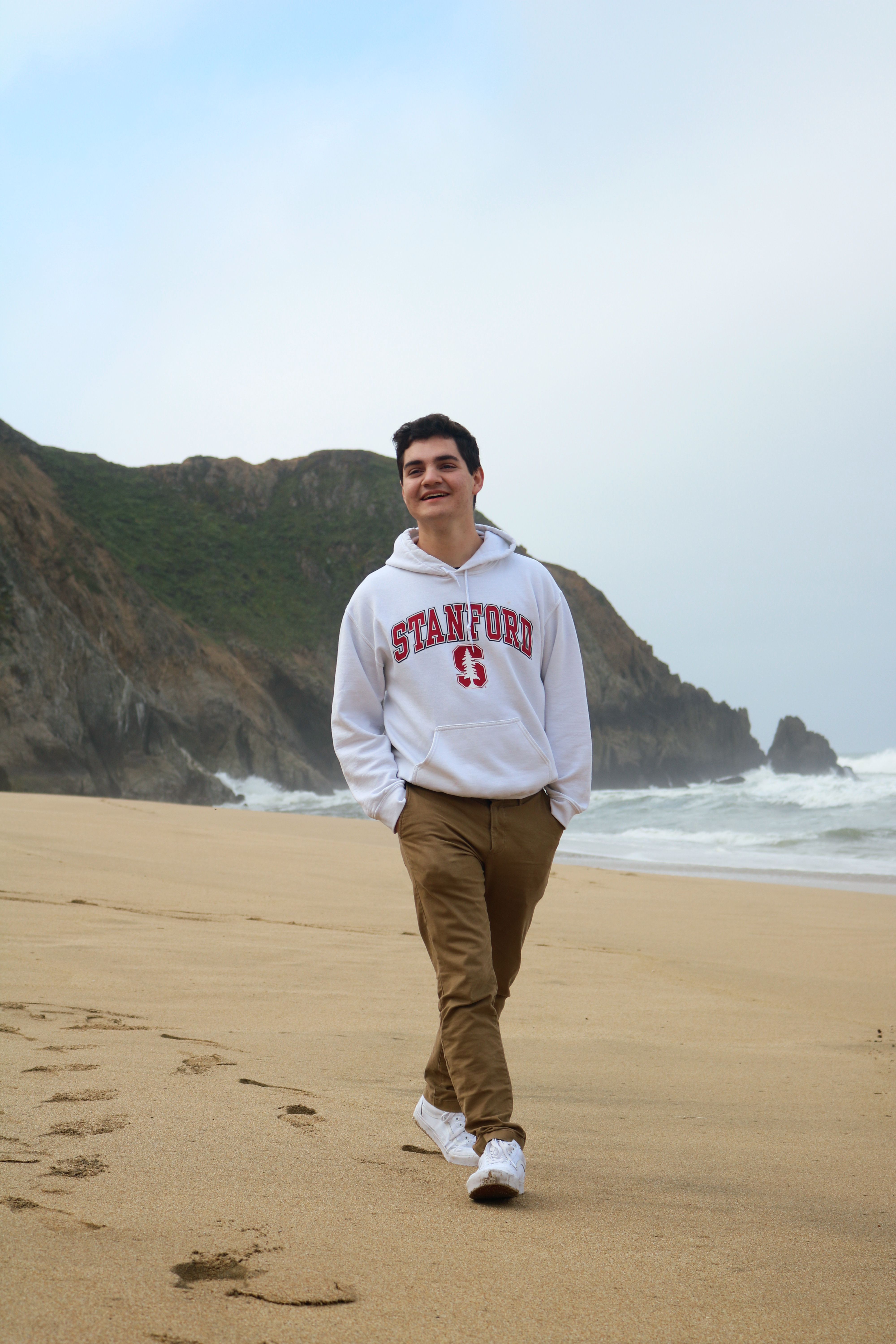 Headshot of Sebastian Ingino walking on a beach